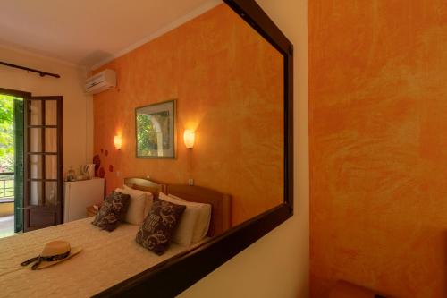 a large mirror on the wall of a bedroom at Villa Litsa in Ermones