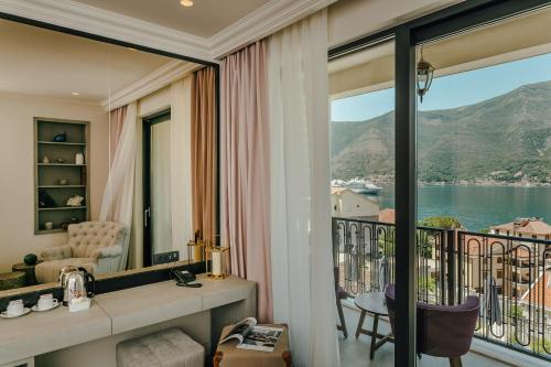 a room with a balcony with a view of the water at Boutique Hotel Casa del Mare - Vizura in Kotor