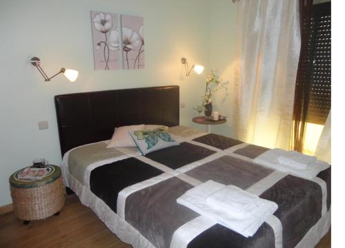 a bedroom with a bed with two towels on it at Ria Apartments in Olhão