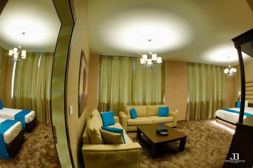 a hotel room with a couch and a bed at Eden Hotel in Beirut