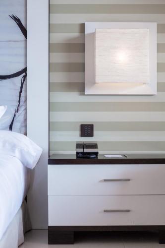 a bedroom with a white dresser with a mirror at Royal Hideaway Sancti Petri in Chiclana de la Frontera