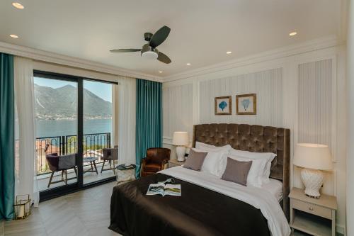 a bedroom with a bed with a view of the water at Boutique Hotel Casa del Mare - Vizura in Kotor