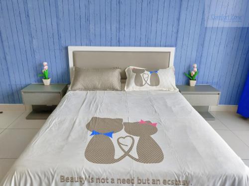 a bedroom with a bed with two bears on it at Comfort Zone Premium Guesthouse @ Evo Bangi in Bangi