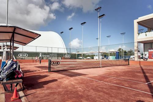 a tennis court with a net on a tennis court at Grand Palladium Costa Mujeres Resort & Spa - All Inclusive in Cancún