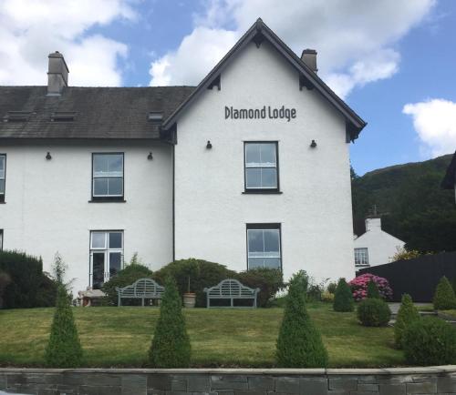 a large white house with the name of theandan lodge at Diamond Lodge Boutique Adults Only Guest House in Ambleside