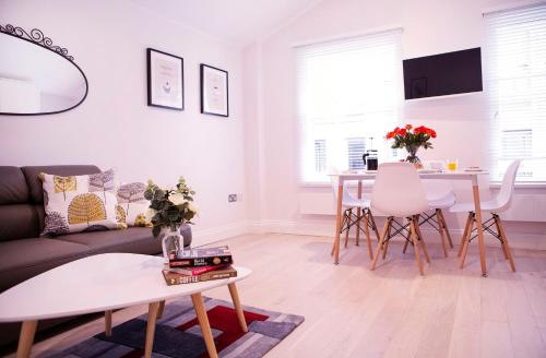 a living room with a couch and a table at Quiet Central West End Apartments by Indigo Flats in London