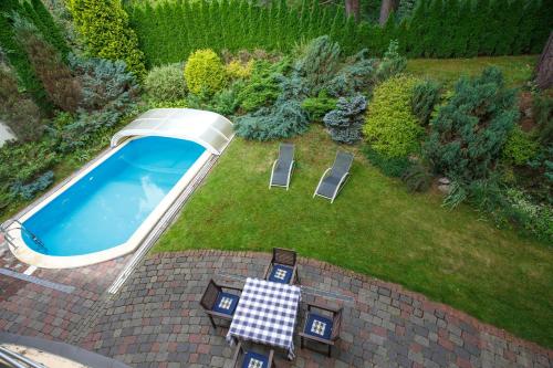 an overhead view of a pool with chairs and a table at Laura in Vilnius