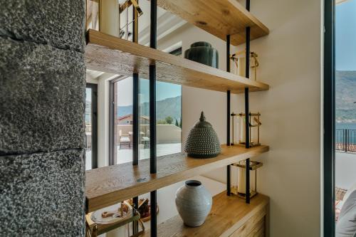 a room with wooden shelves with vases on them at Boutique Hotel Casa del Mare - Vizura in Kotor
