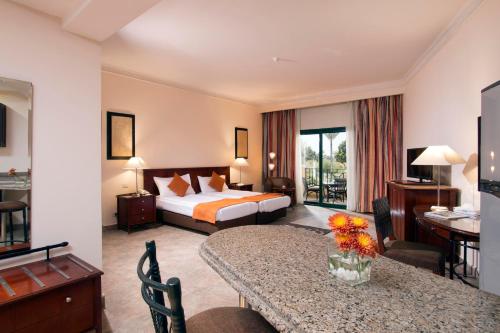 A bed or beds in a room at Swiss Inn Plaza Hotel