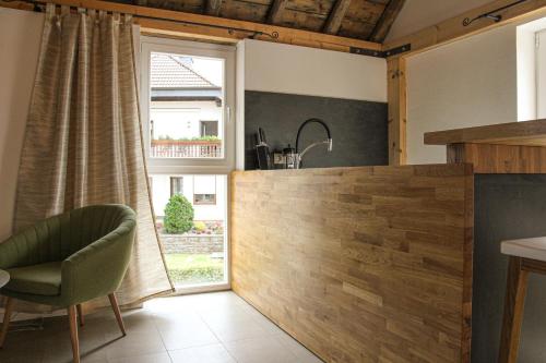 eine Küche mit einem grünen Stuhl und einem Fenster in der Unterkunft Ferienhaus am Rheinsteig / Nähe Hindenburghöhe / Loreley in Lykershausen
