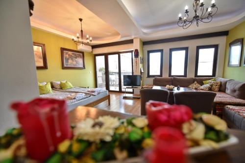 a living room with couches and a couch and windows at Jovanovic Guest House in Ohrid