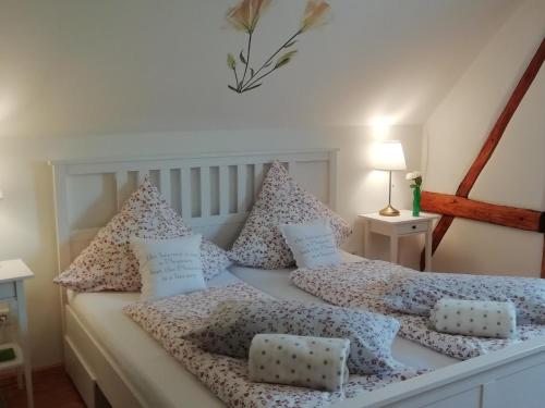 a bedroom with a bed with pillows on it at Ferienhaus am Haselbach in Ebershausen