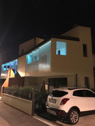 a white car parked in front of a house at night at Villa Alcova in Caorle