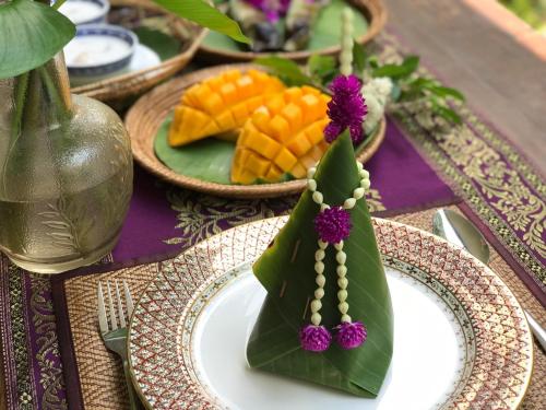 a table with plates of food on a table at SSIP Boutique Dhevej Bangkok in Bangkok