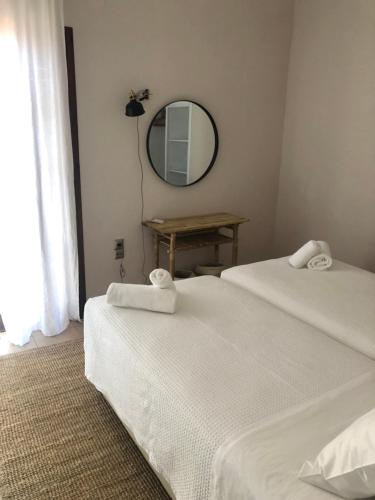 two beds in a room with a mirror and a table at Apartment Sunkiss in Almirida
