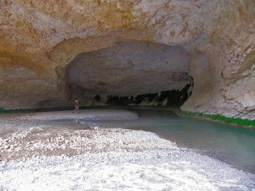 a person standing in the water in a cave at Hotel Castillo de Alquézar in Alquézar
