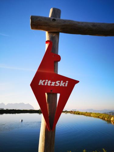 a wooden cross with the word krishicism on it at Hocheckhuette On Top of the Kitzbuehel Hahnenkamm Mountain in Kitzbühel