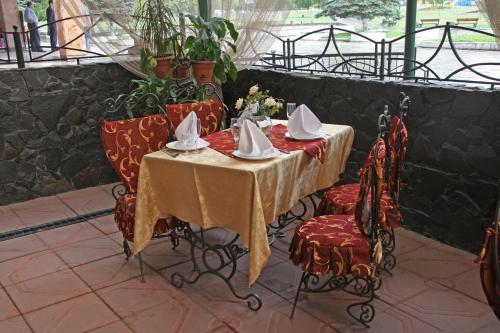 a table with plates and napkins on top of it at Ekran Hotel in Lviv