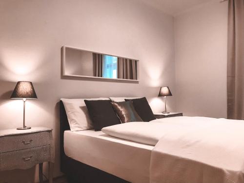 a bedroom with a bed and a mirror on the wall at Luxury apartments only for Business Travel in Salzburg
