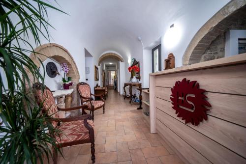 a hallway of a house with chairs and a wall at Hotel Sole in Assisi