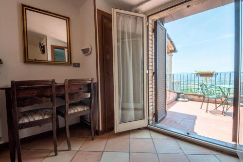 a room with a sliding glass door and a balcony at Hotel Sole in Assisi
