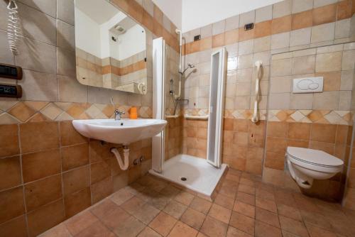 a bathroom with a shower and a sink and a toilet at Hotel Sole in Assisi