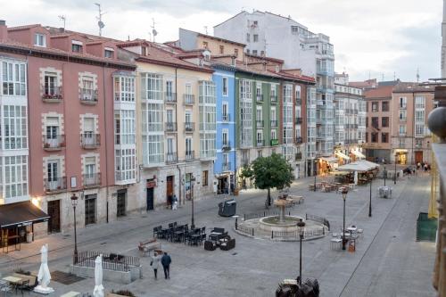a city street with buildings and people walking around at Hostel Catedral Burgos in Burgos