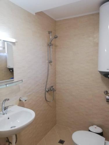 a bathroom with a sink and a shower at Guest House Dimovi in Sozopol