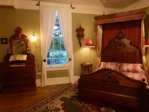 a bedroom with a large bed and a window at Mulberry Lavender Farm and B&B in Mulberry