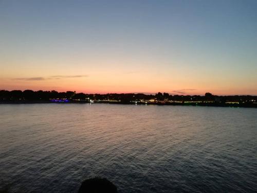 a sunset over a large body of water at Guest House Dimovi in Sozopol