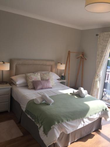 a bedroom with a large bed with towels on it at Coral Gables Guesthouse & Campsite in Rosslare