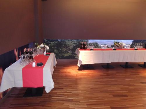 two tables with wine glasses on them in a room at Hotel Río Hortega in Valladolid