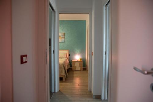 a hallway with a bedroom and a bed in a room at Il Sole in San Vito lo Capo