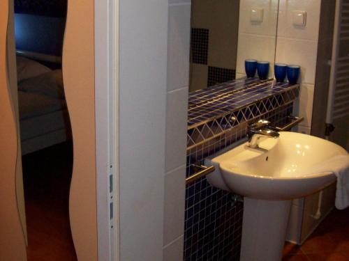 a bathroom with a sink and a mirror at Miróbile in Berlin