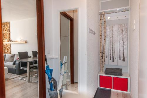 a living room with a red cabinet and a living room at Modern & schöner Ausblick in Hahnenklee-Bockswiese