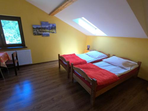 a bedroom with two beds in a room at Ośrodek Wczasowy Wierchy in Korbielów