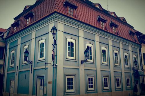 a large white building with a red roof at Duna Panzió in Győr