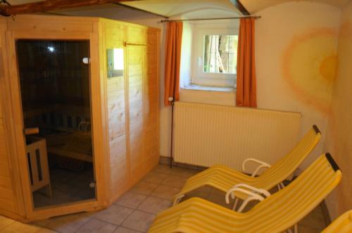 a room with two yellow chairs and a window at Obervostlhaus - Sehr schöne gemütliche Almhütte der besonderen Art in Ebene Reichenau
