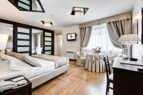 a hotel room with a bed and a desk and a table at Best Western Hotel Rocca in Cassino