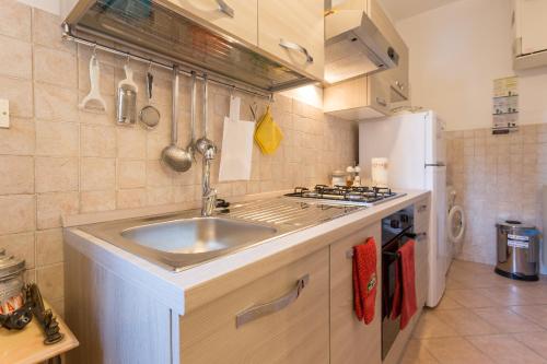 a kitchen with a sink and a refrigerator at Il Profumo del Lauro in Perugia