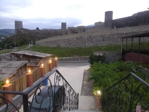 a view from the balcony of a castle at night at Old Gate Inn in Akhaltsikhe