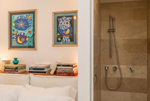 a bathroom with a shower and a bed and books at Masseria Limonaia & Spa in Fasano
