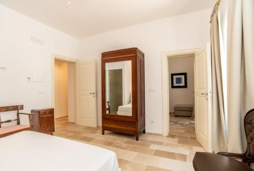a bedroom with a dresser and a mirror at Masseria Limonaia & Spa in Fasano