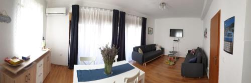 a living room with a couch and a chair at Central, spacious, great view in Hvar