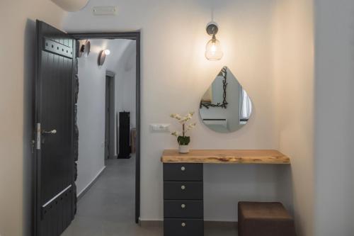 a hallway with a dressing table and a mirror at Secret Spot Luxury Villa in Fira