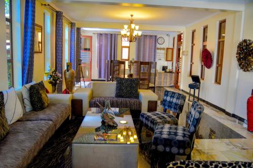 
a living room filled with furniture and decor at Tulia Boutique Hotel & Spa in Arusha
