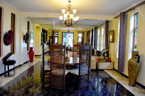 a lobby with a table and chairs and a chandelier at Tulia Boutique Hotel & Spa in Arusha
