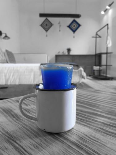 a blue cup is sitting in a pot on a table at Santa Josefita B&B in Cholula