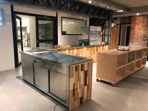 a large kitchen with a counter and some boxes at Hotel Eco Max in San Carlos de Bariloche