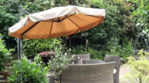 an orange umbrella sitting on top of a table at The Mills Guesthouse in Hatfield